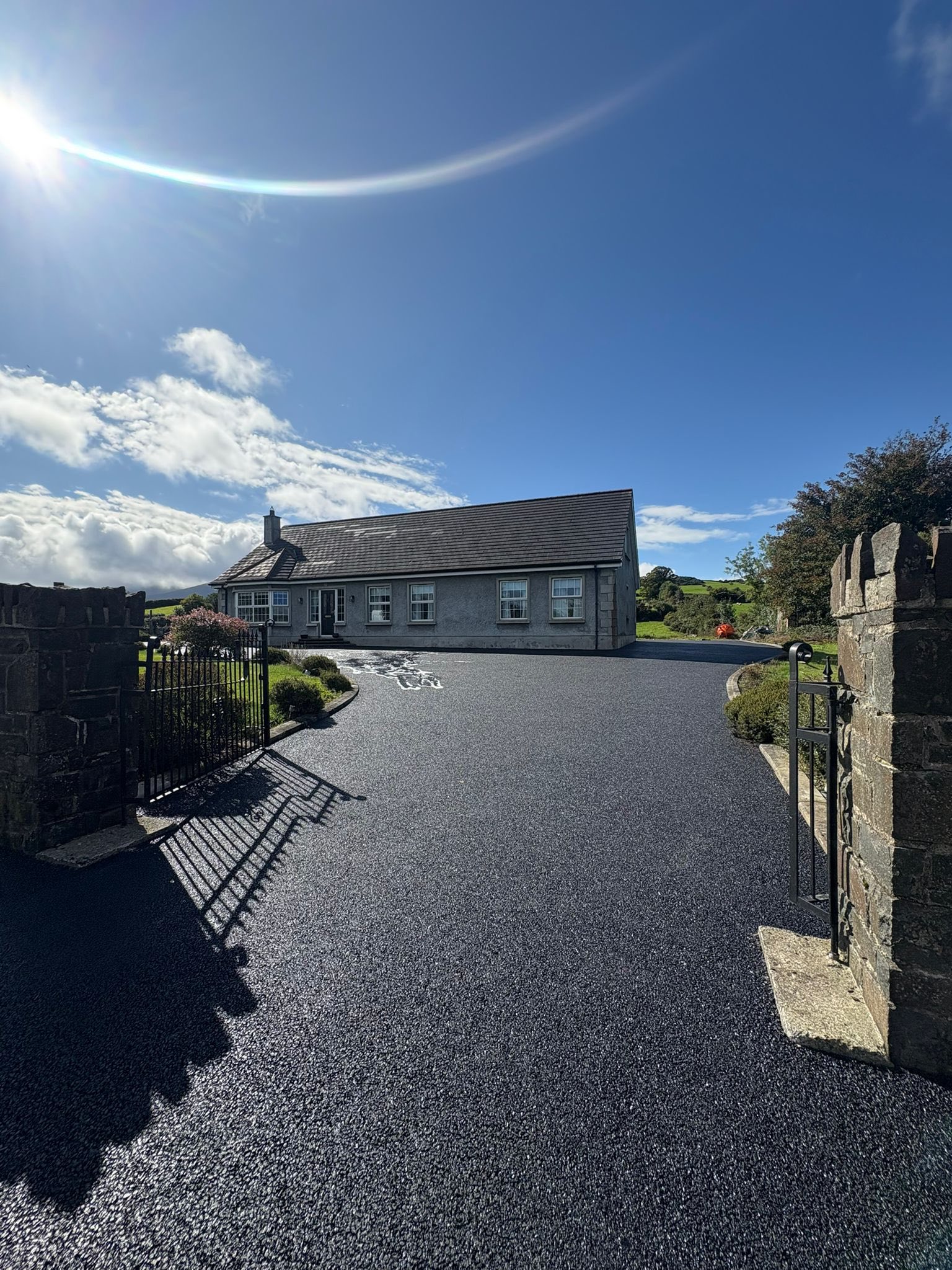 Crisp black tarmac surface with defined kerb line