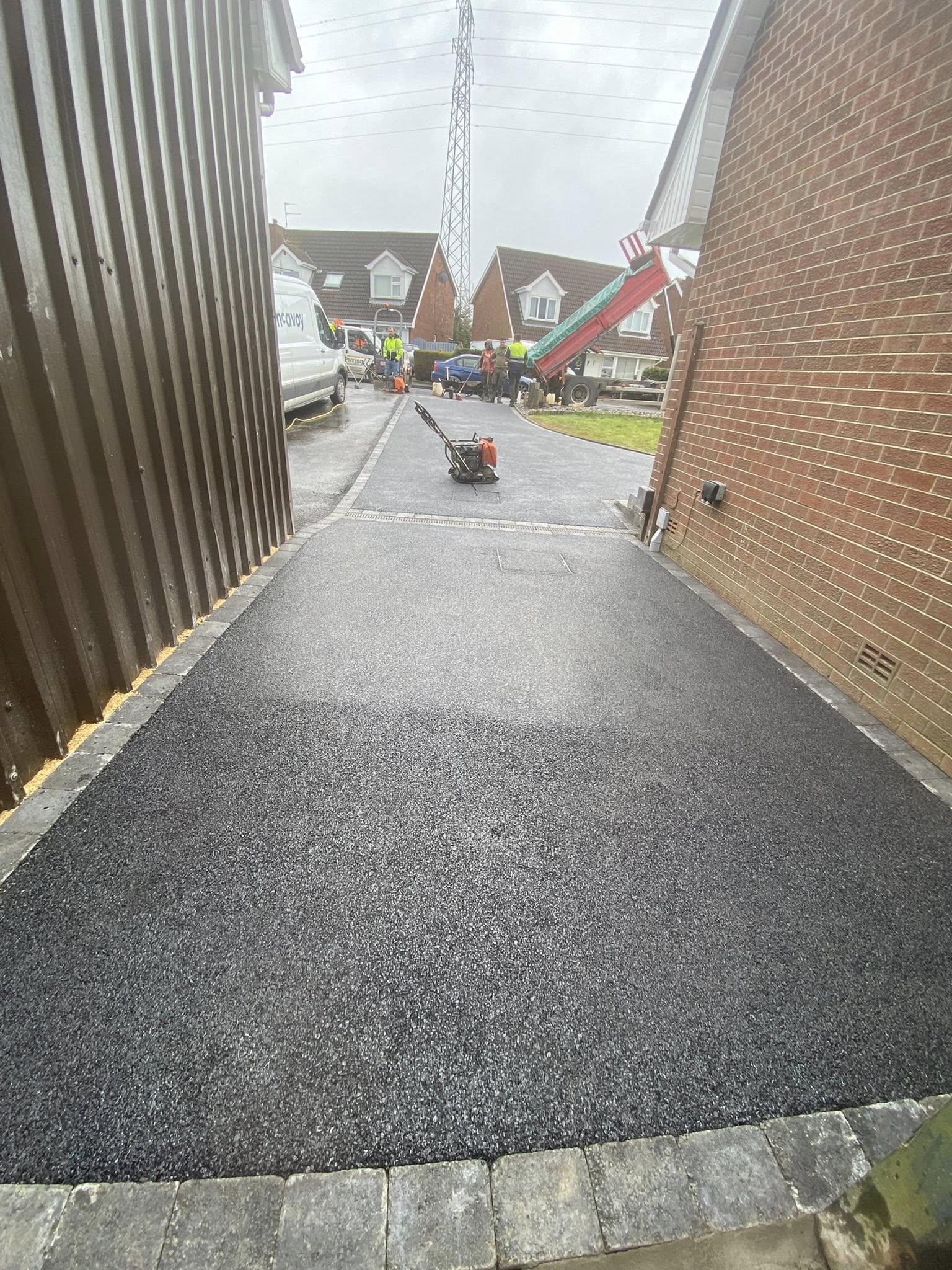 Large-format domestic driveway in deep black tarmac