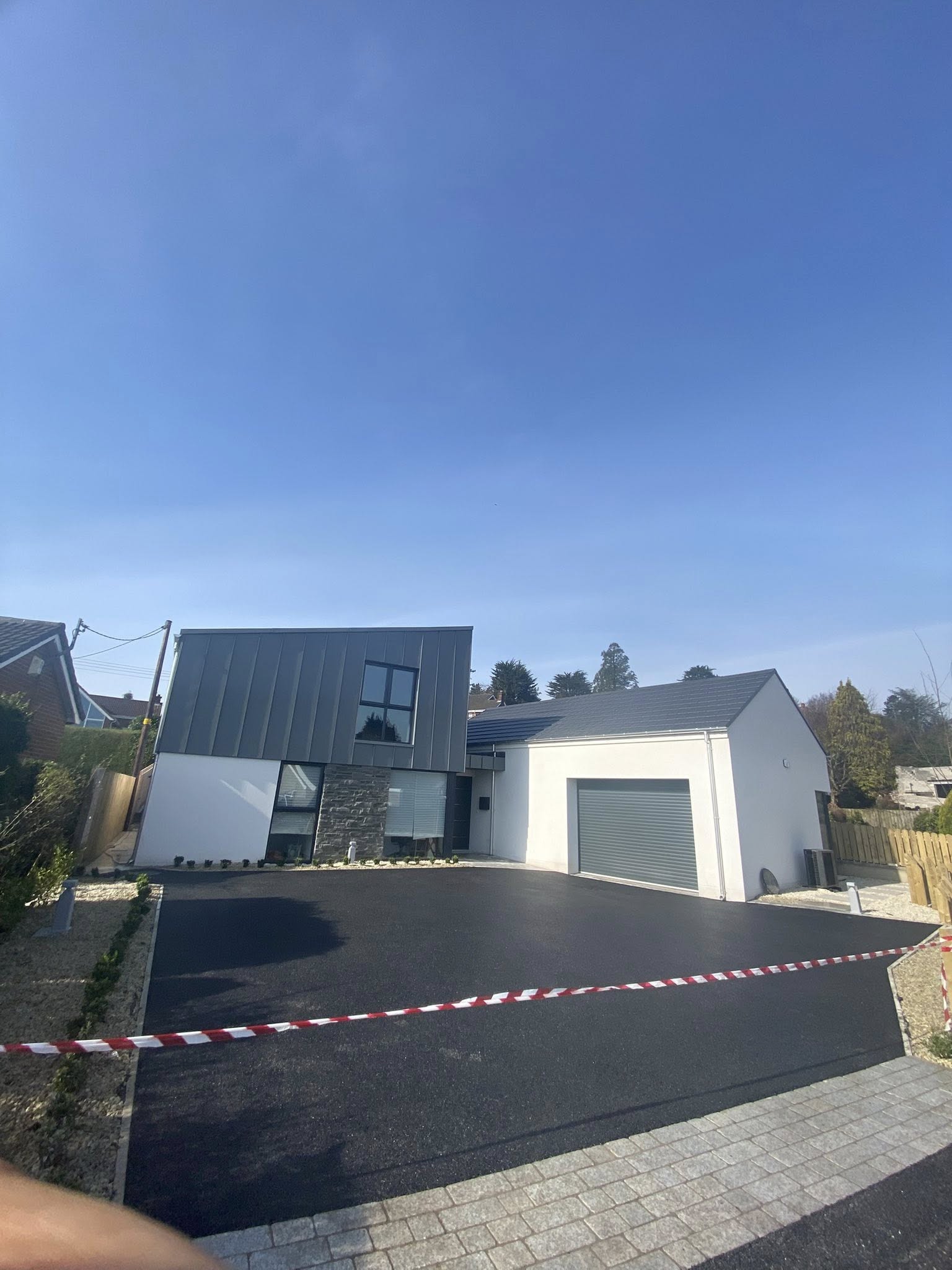 Freshly laid tarmac driveway with clean block-paved border